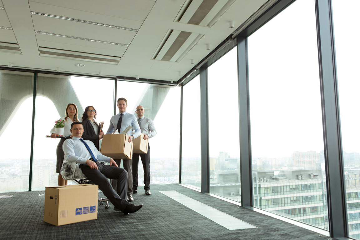 A group of people in an office ready to move in.